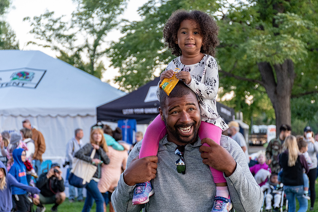 father and daughter at a community park event