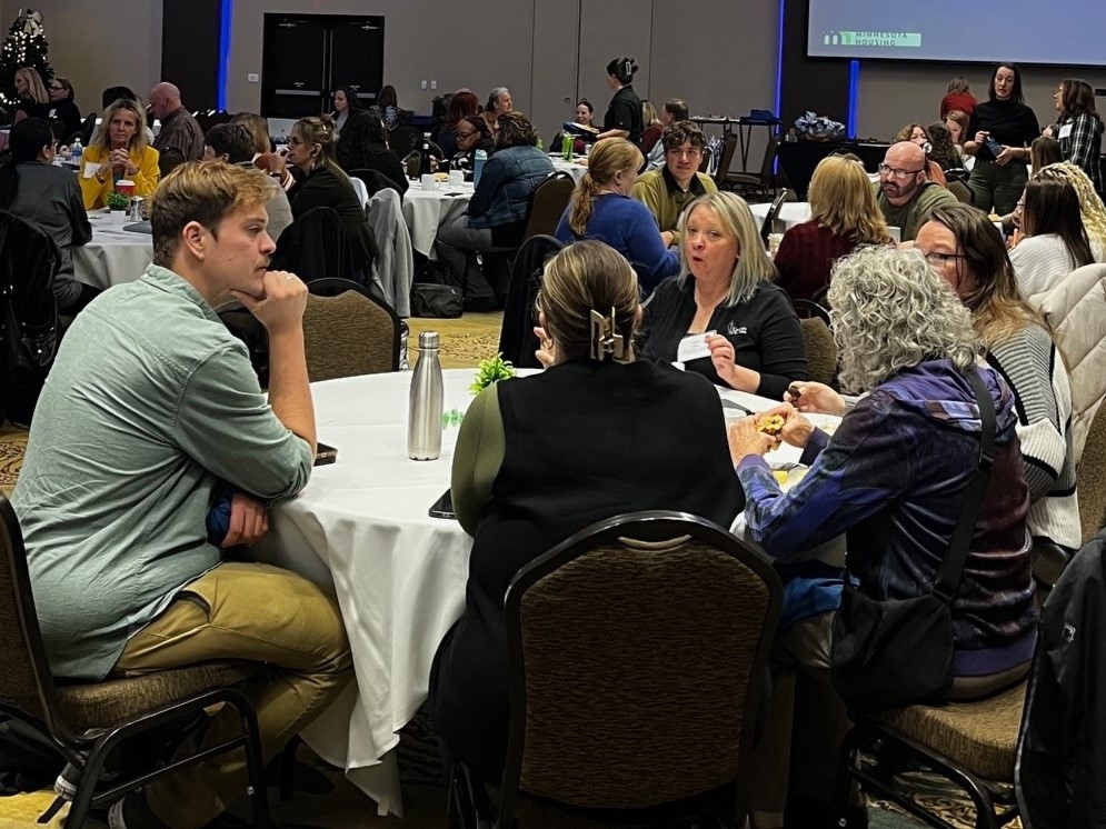 Forum attendees engaged in table discussion 