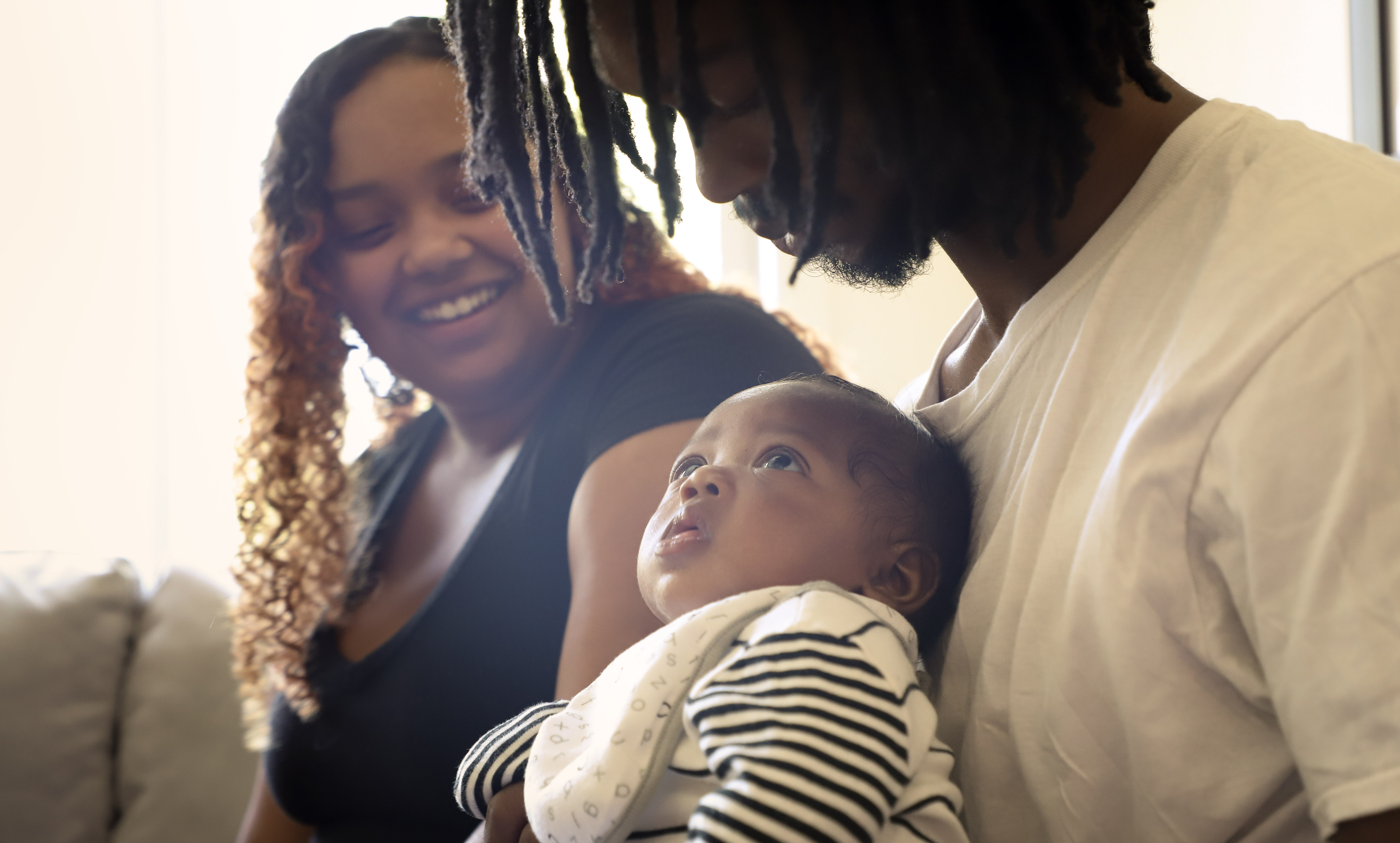 Man_holding_baby_with_woman