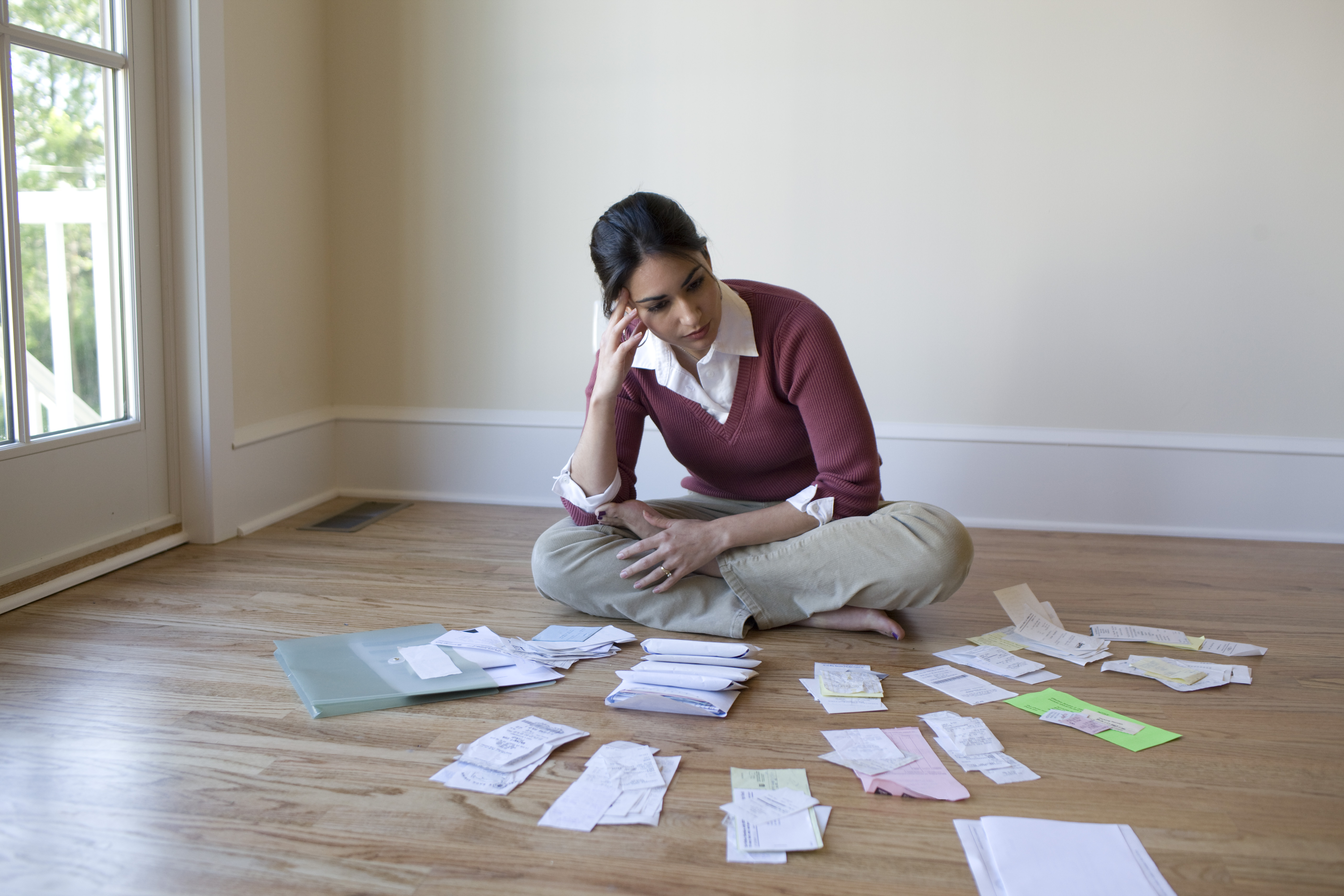 Woman looking at bills on floor